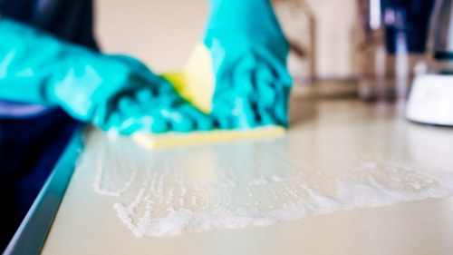 Sanitizing office surfaces as part of regular cleaning