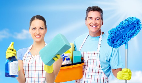 Commercial cleaning team sanitizing a modern workplace meeting room